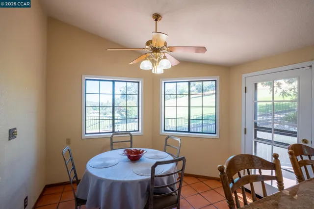 a dining room with furniture a chandelier and window