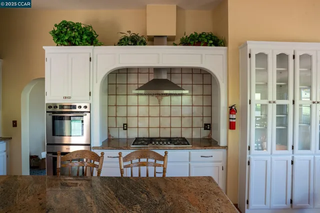 a close view of a sink and a stove in a kitchen