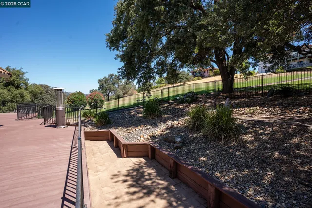 a aerial view of a house with yard and green space
