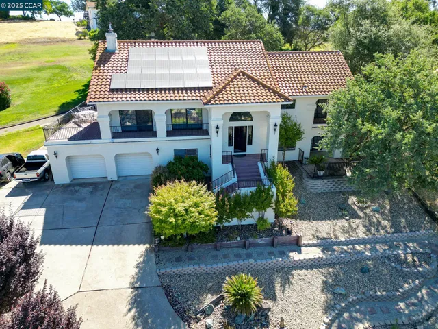 an aerial view of a house with a yard
