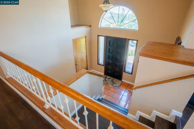 a view of a balcony and dining room