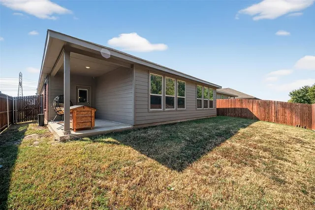 a view of a backyard with wooden fence