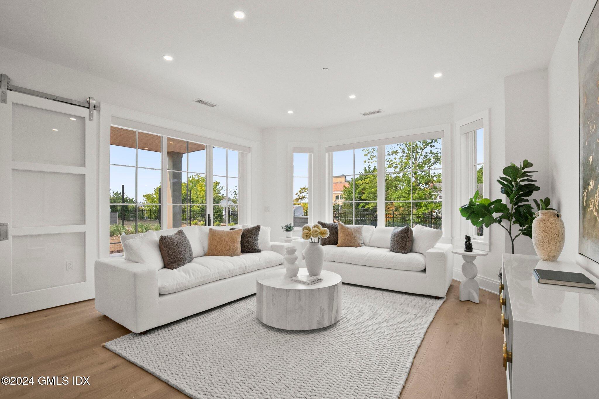71 Havemeyer Place, Unit 303S Greenwich, CT 06830 - Photo 11 of 26 a living room with furniture and a large window