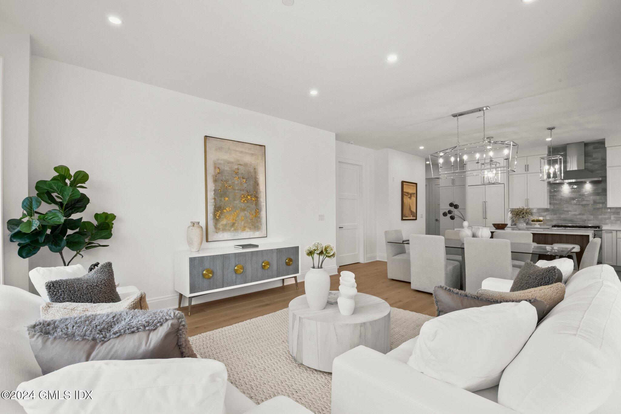 71 Havemeyer Place, Unit 303S Greenwich, CT 06830 - Photo 12 of 26 a living room with furniture and a chandelier