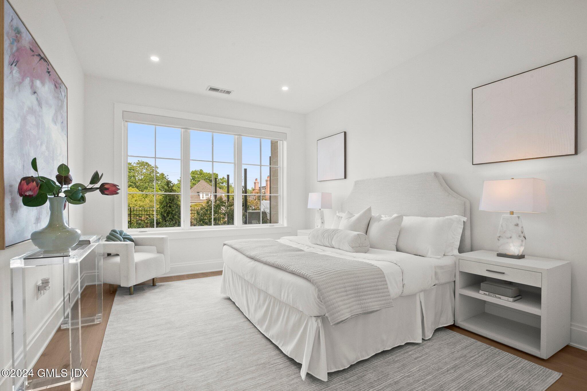 71 Havemeyer Place, Unit 303S Greenwich, CT 06830 - Photo 16 of 26 a bedroom with bed and large window