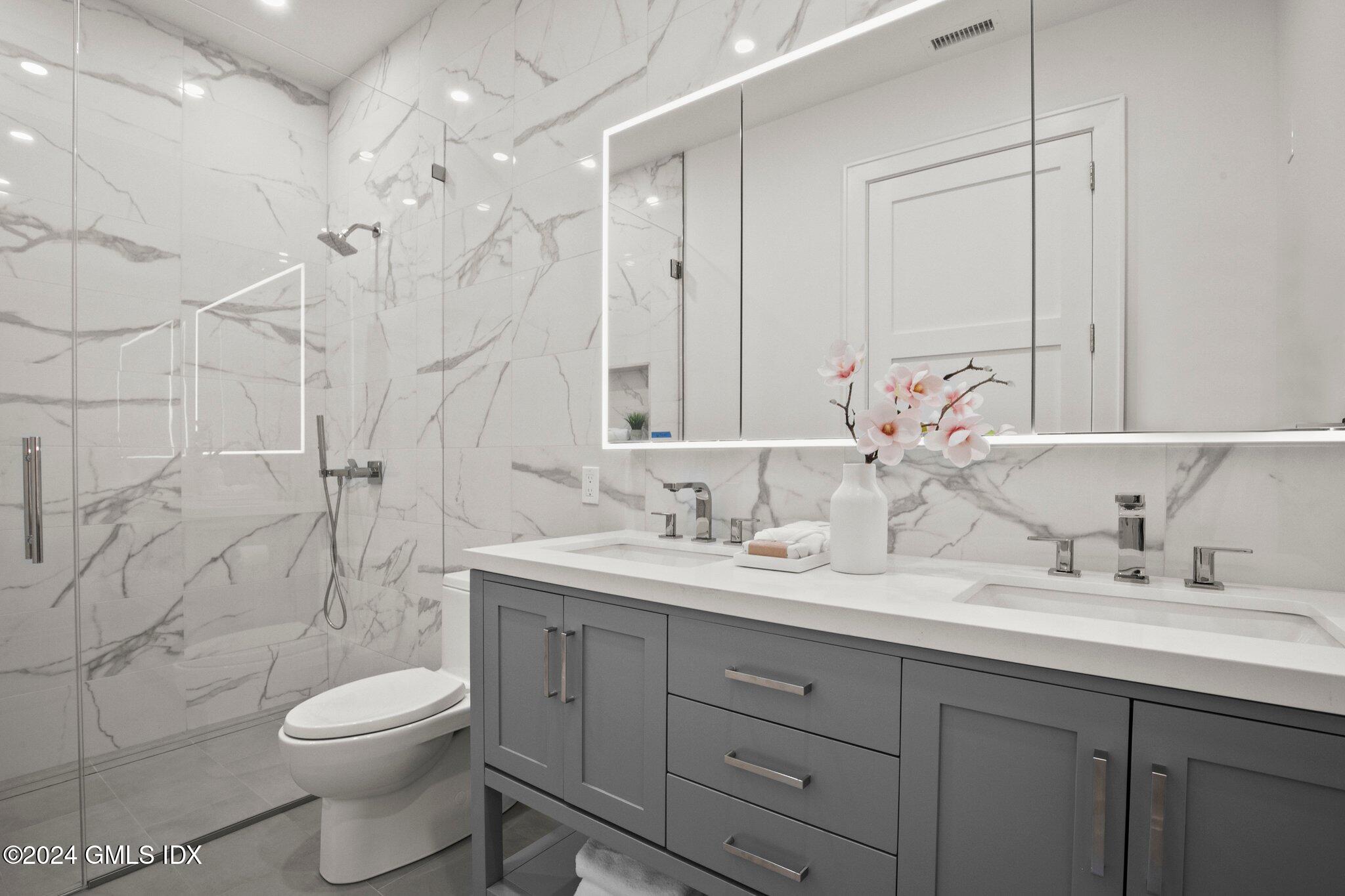 71 Havemeyer Place, Unit 303S Greenwich, CT 06830 - Photo 20 of 26 a bathroom with a double vanity sink toilet and shower