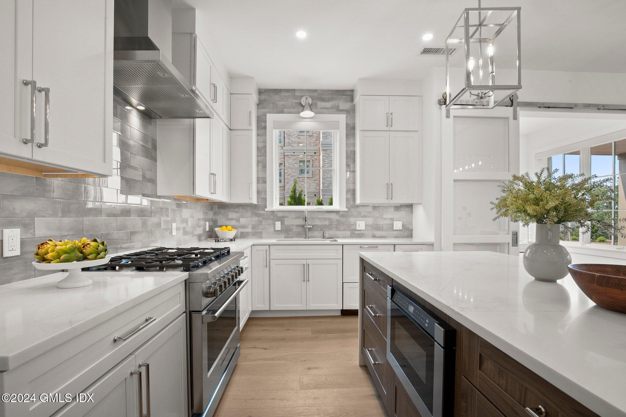 71 Havemeyer Place, Unit 303S Greenwich, CT 06830 - Photo 3 of 26 a kitchen with stainless steel appliances a sink a stove cabinets and a counter top space