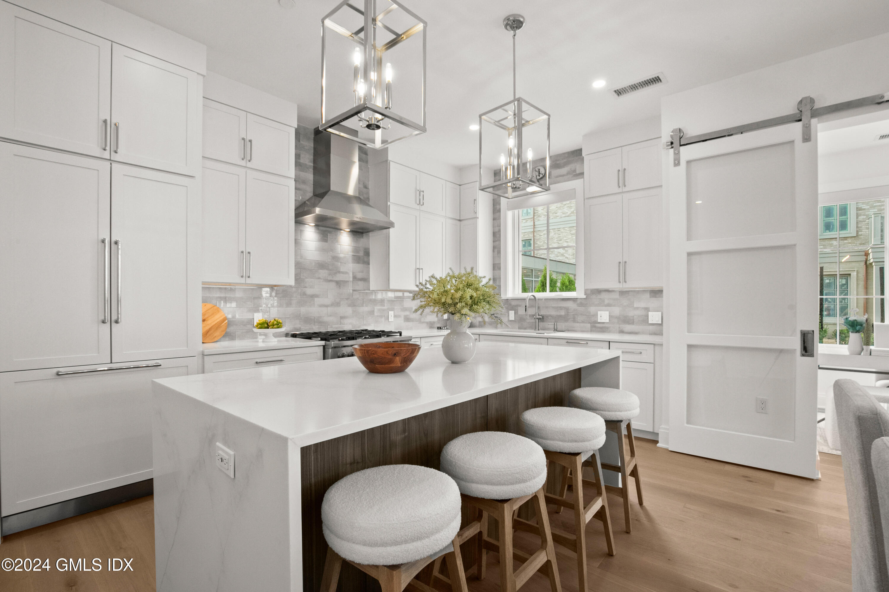 71 Havemeyer Place, Unit 303S Greenwich, CT 06830 - Photo 5 of 26 a kitchen with kitchen island a sink table and chairs