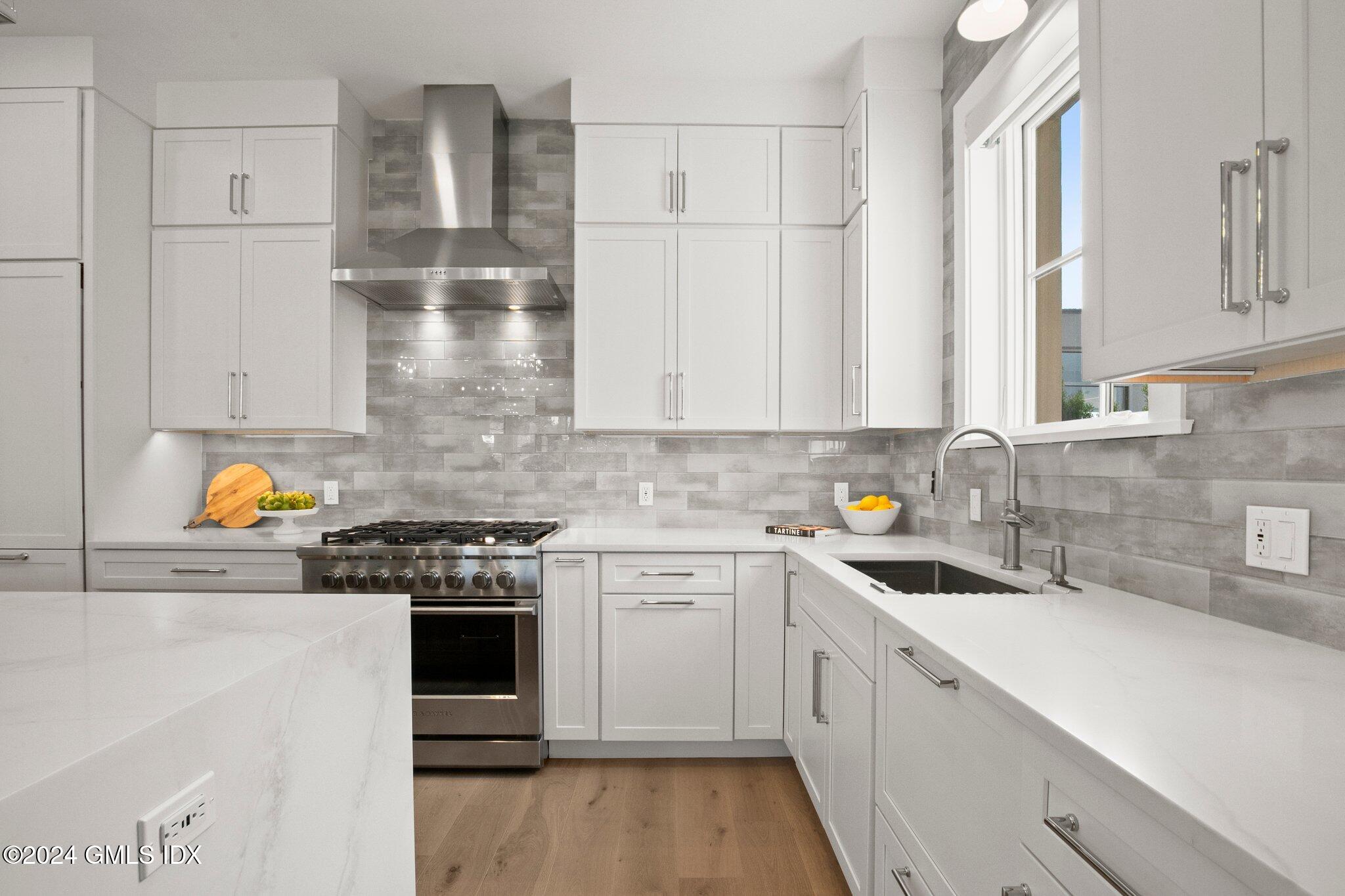71 Havemeyer Place, Unit 303S Greenwich, CT 06830 - Photo 7 of 26 a kitchen with stainless steel appliances granite countertop a stove a sink and a refrigerator