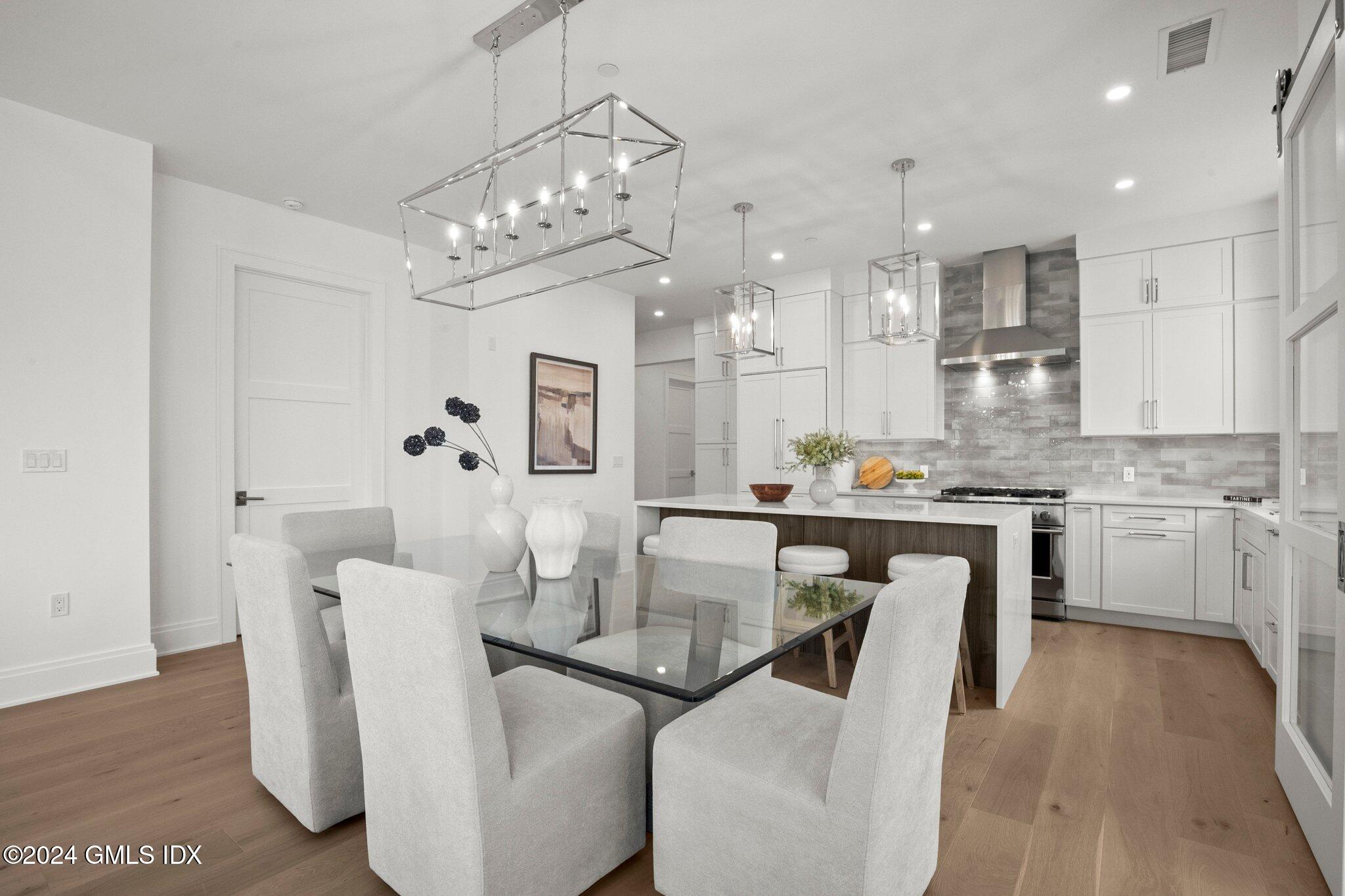 71 Havemeyer Place, Unit 303S Greenwich, CT 06830 - Photo 8 of 26 a living room with kitchen island furniture and a chandelier