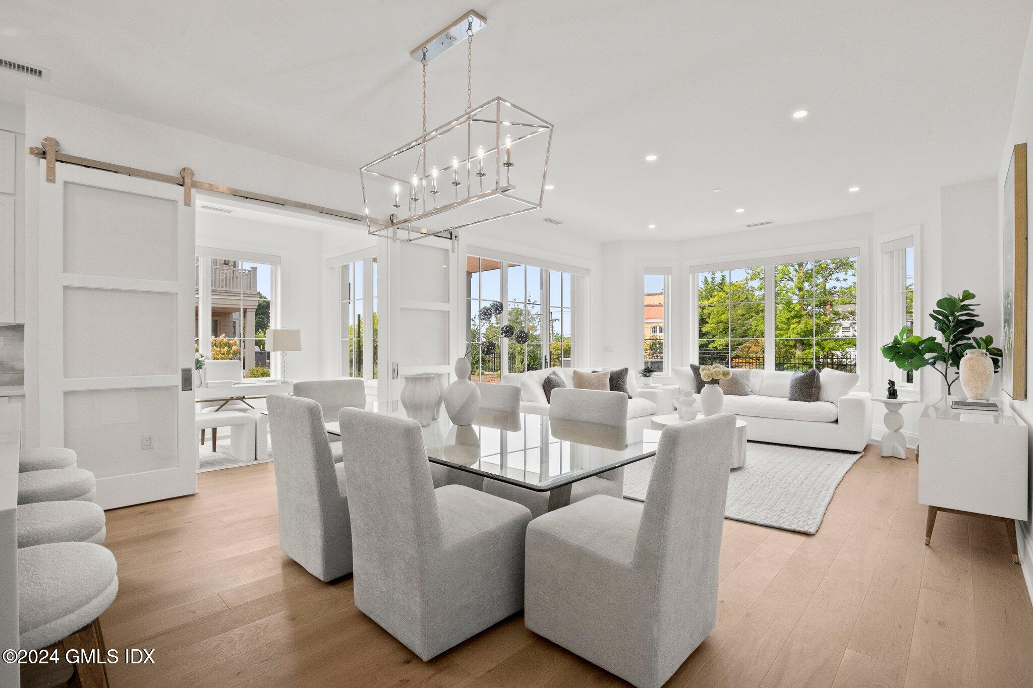 71 Havemeyer Place, Unit 303S Greenwich, CT 06830 - Photo 10 of 26 a living room with furniture wooden floor and a chandelier
