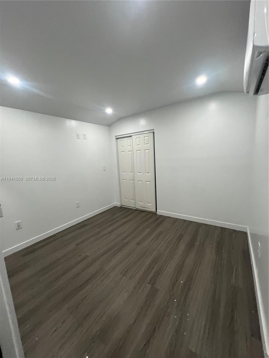 21600 Southwest 260th Street Homestead, FL 33031 - Photo 11 of 23 an empty room with wooden floor and windows