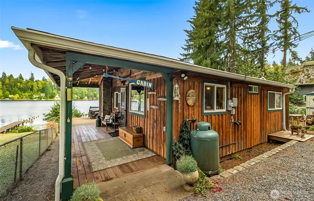 a view of a porch with furniture and a backyard