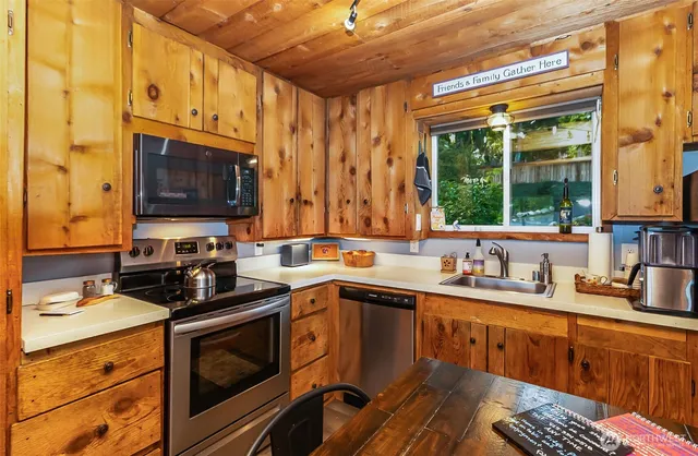 a kitchen with a sink stove and microwave