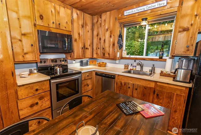a kitchen with stainless steel appliances a sink stove and cabinets