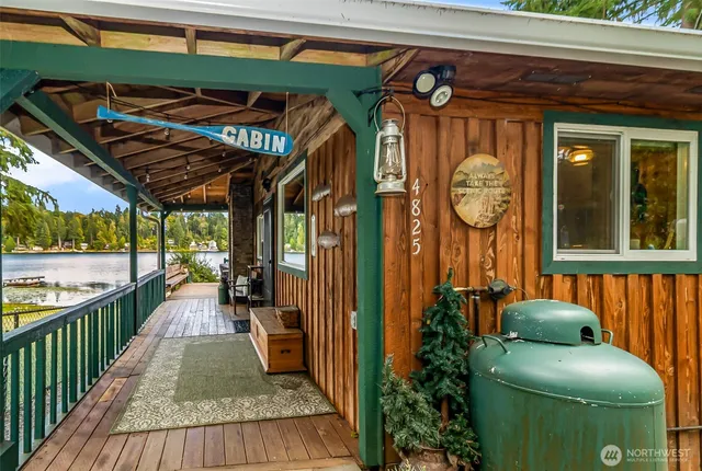 a view of a porch with furniture and a swing