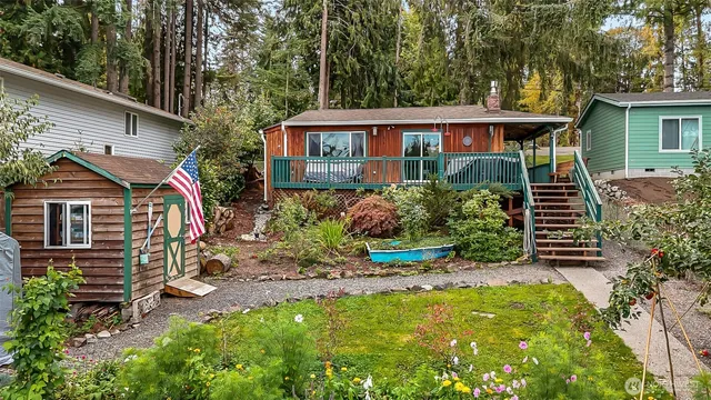 a view of a house with a yard and potted plants