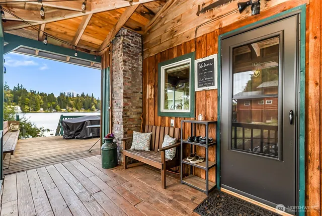 a view of a balcony with chairs and wooden floor