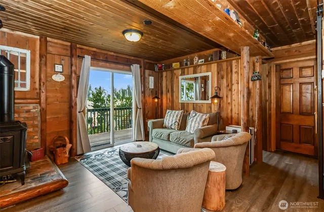 a living room with furniture and a floor to ceiling window