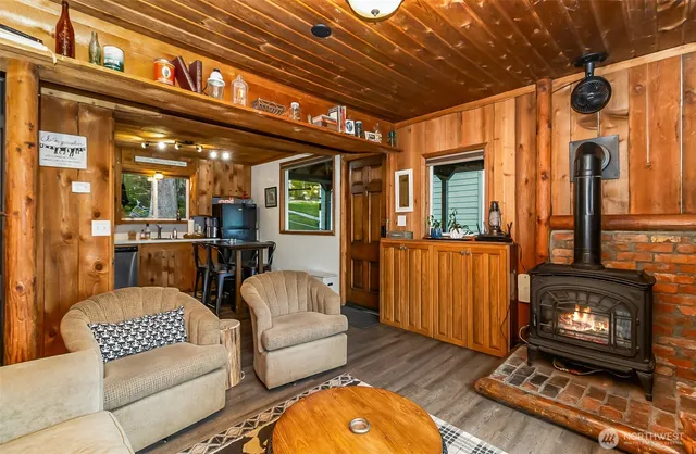 a living room with furniture a rug and a fireplace
