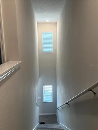 a kitchen with a refrigerator sink and cabinets