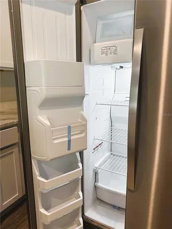 a kitchen with stainless steel appliances a refrigerator sink and microwave