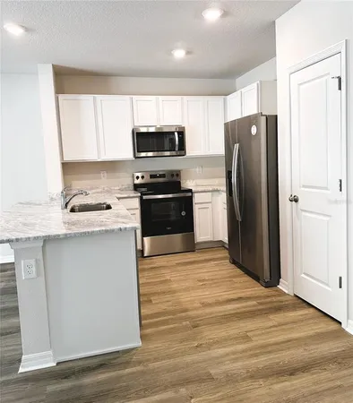 a stove top oven sitting inside of a kitchen
