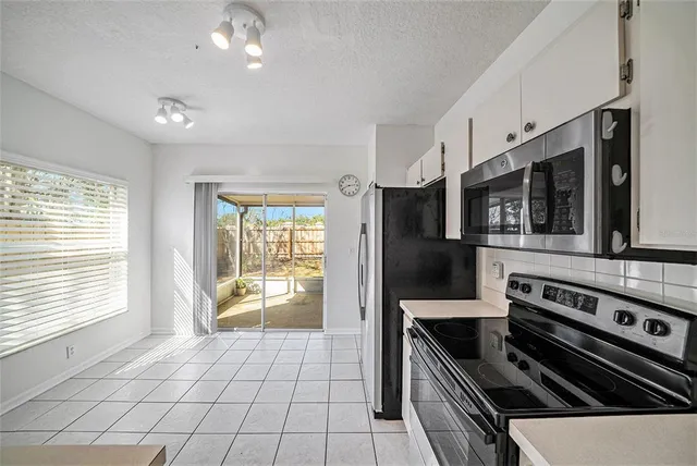 a kitchen with stainless steel appliances a stove a microwave and cabinets