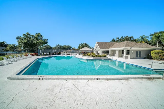 a view of a house with pool and a yard