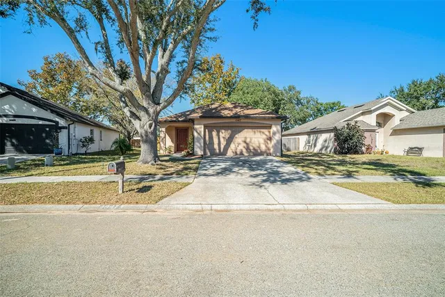 a view of a house with snow on the road