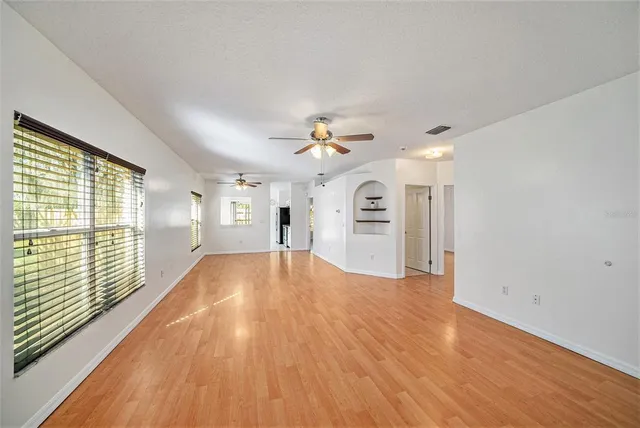 a view of a livingroom with a ceiling fan and window