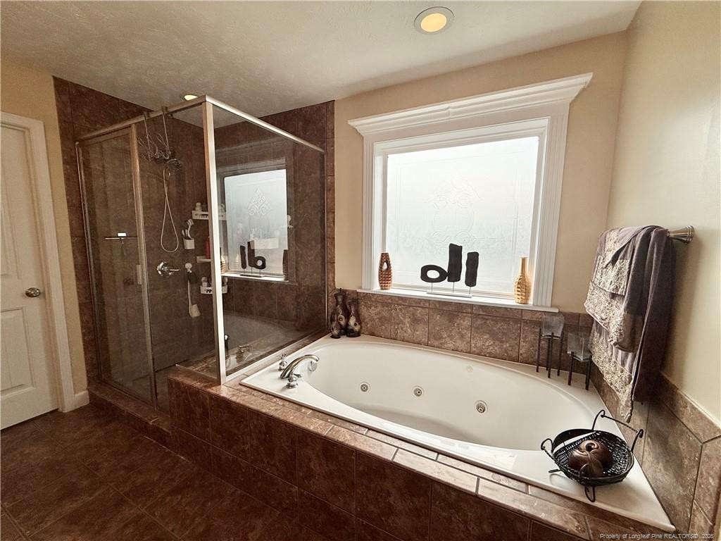 35 Ambrose Point Cameron, NC 28326 - Photo 21 of 31 a bathroom with a tub and a shower
