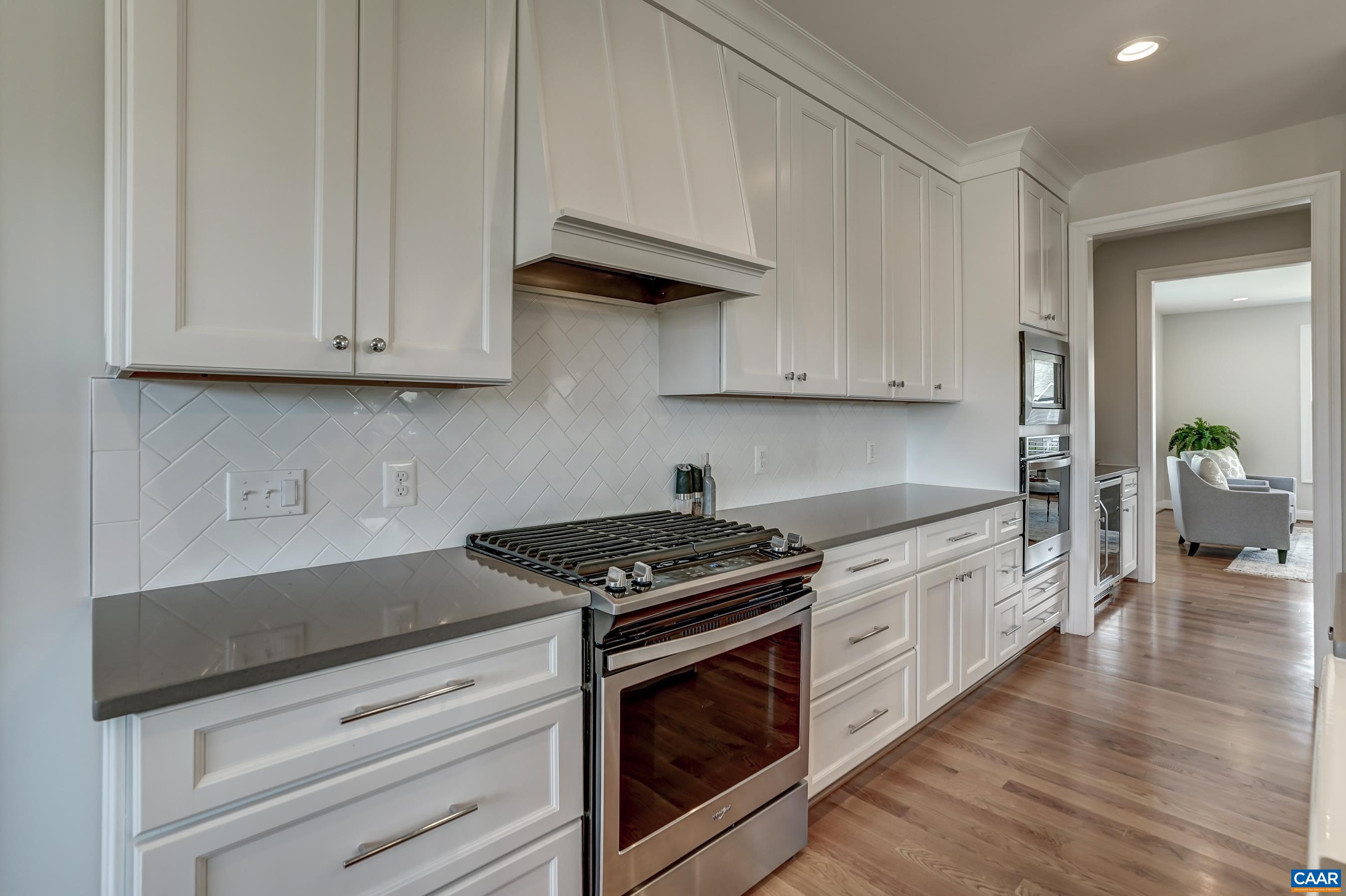 424 Claibourne Road Crozet, VA 22932 - Photo 16 of 64 a kitchen with granite countertop white cabinets and stainless steel appliances