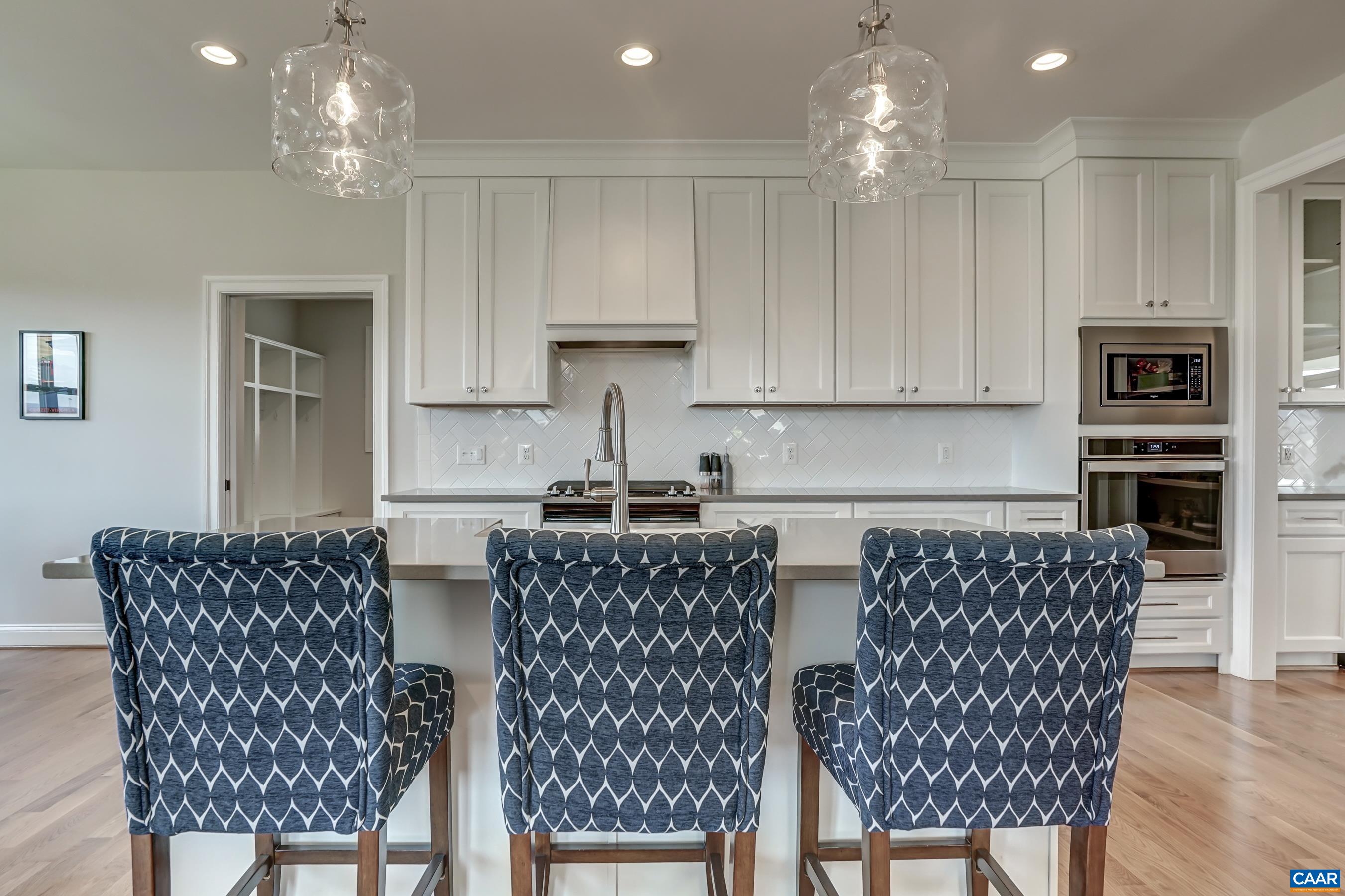 424 Claibourne Road Crozet, VA 22932 - Photo 18 of 64 a kitchen with stainless steel appliances granite countertop a white table and chairs