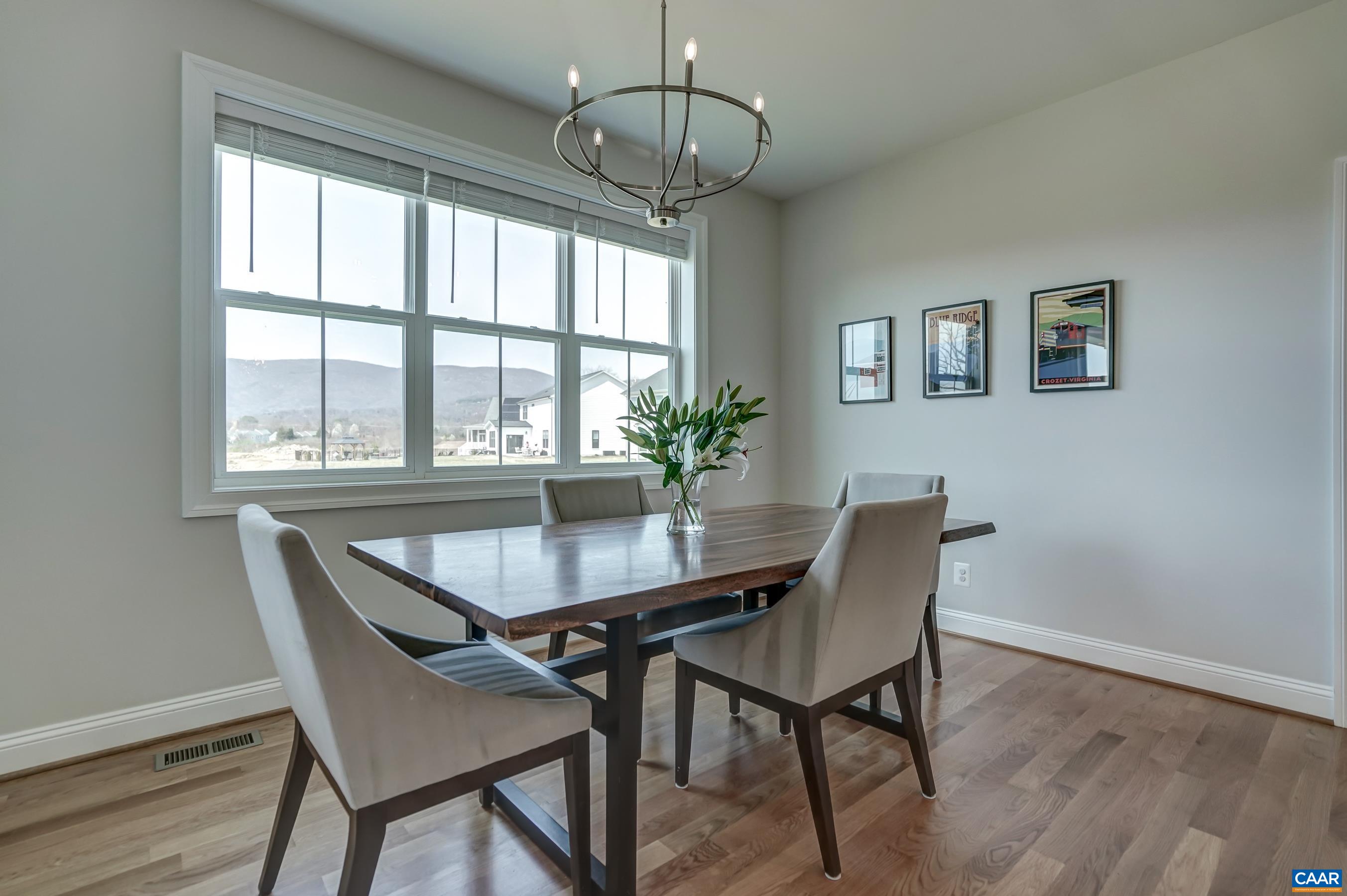 424 Claibourne Road Crozet, VA 22932 - Photo 25 of 64 a dining room with furniture a chandelier and wooden floor