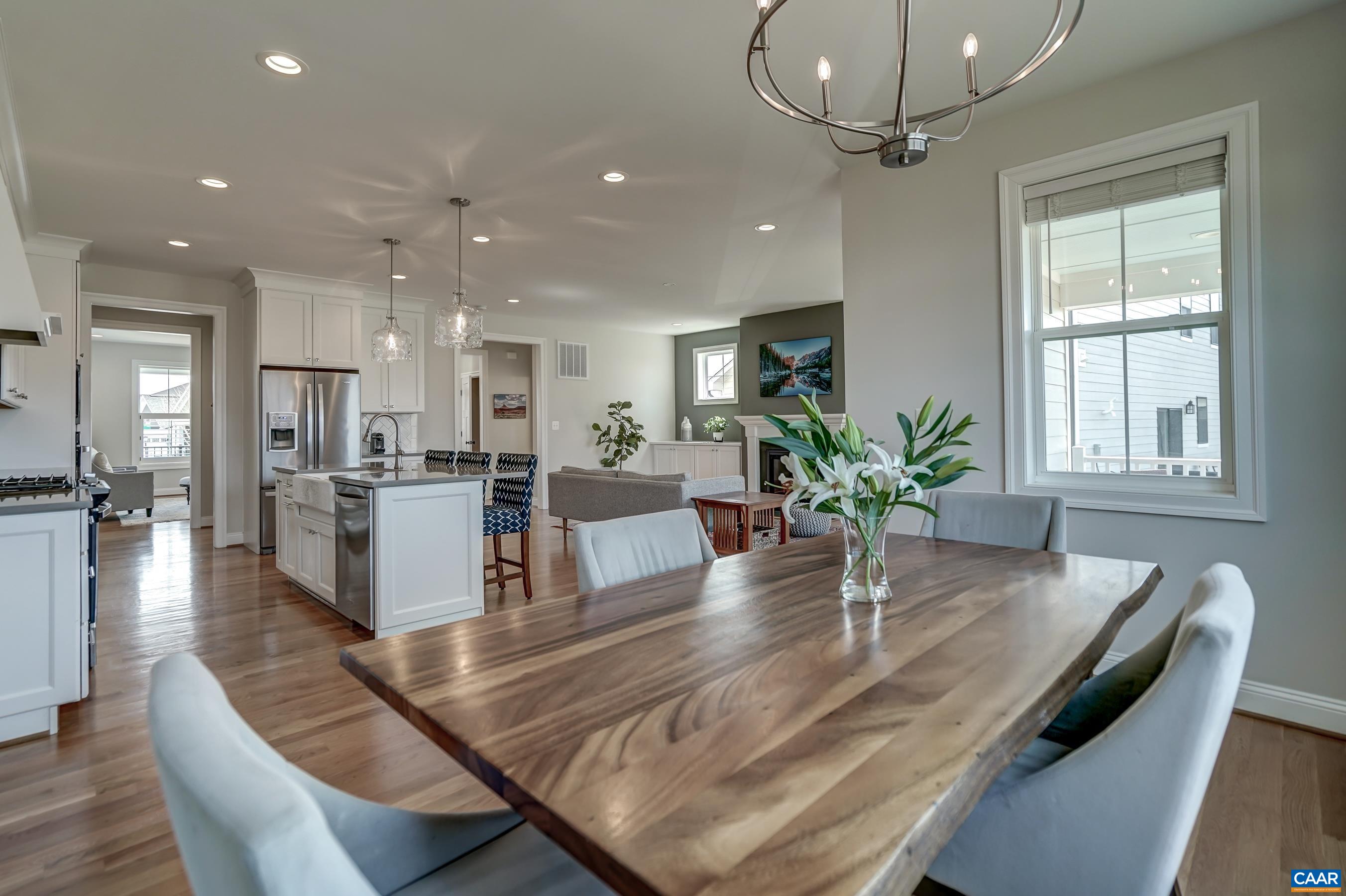 424 Claibourne Road Crozet, VA 22932 - Photo 26 of 64 a living room with kitchen island furniture and a chandelier