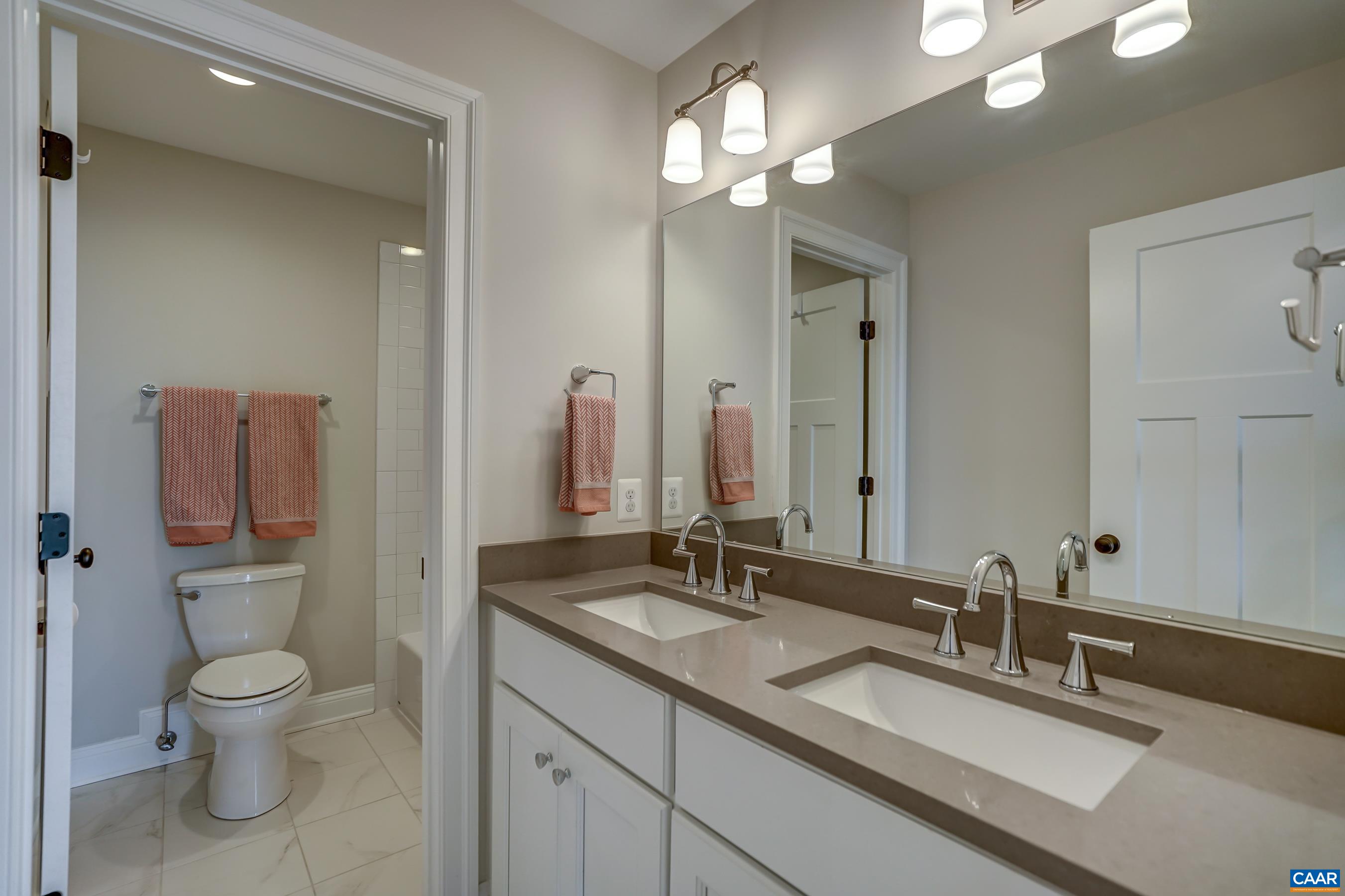 424 Claibourne Road Crozet, VA 22932 - Photo 42 of 64 a bathroom with a toilet a sink and mirror