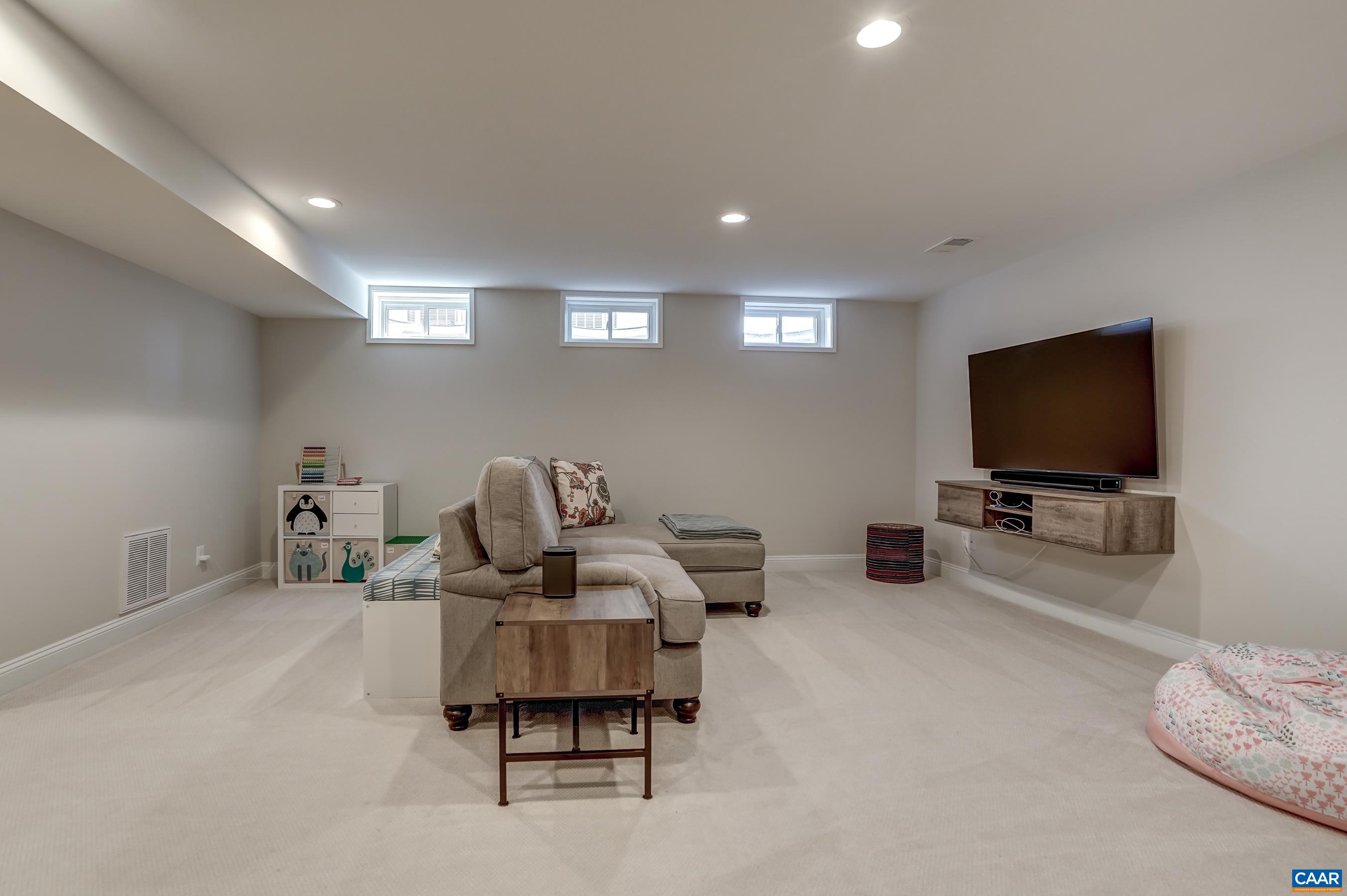 424 Claibourne Road Crozet, VA 22932 - Photo 45 of 64 a living room with furniture and a flat screen tv