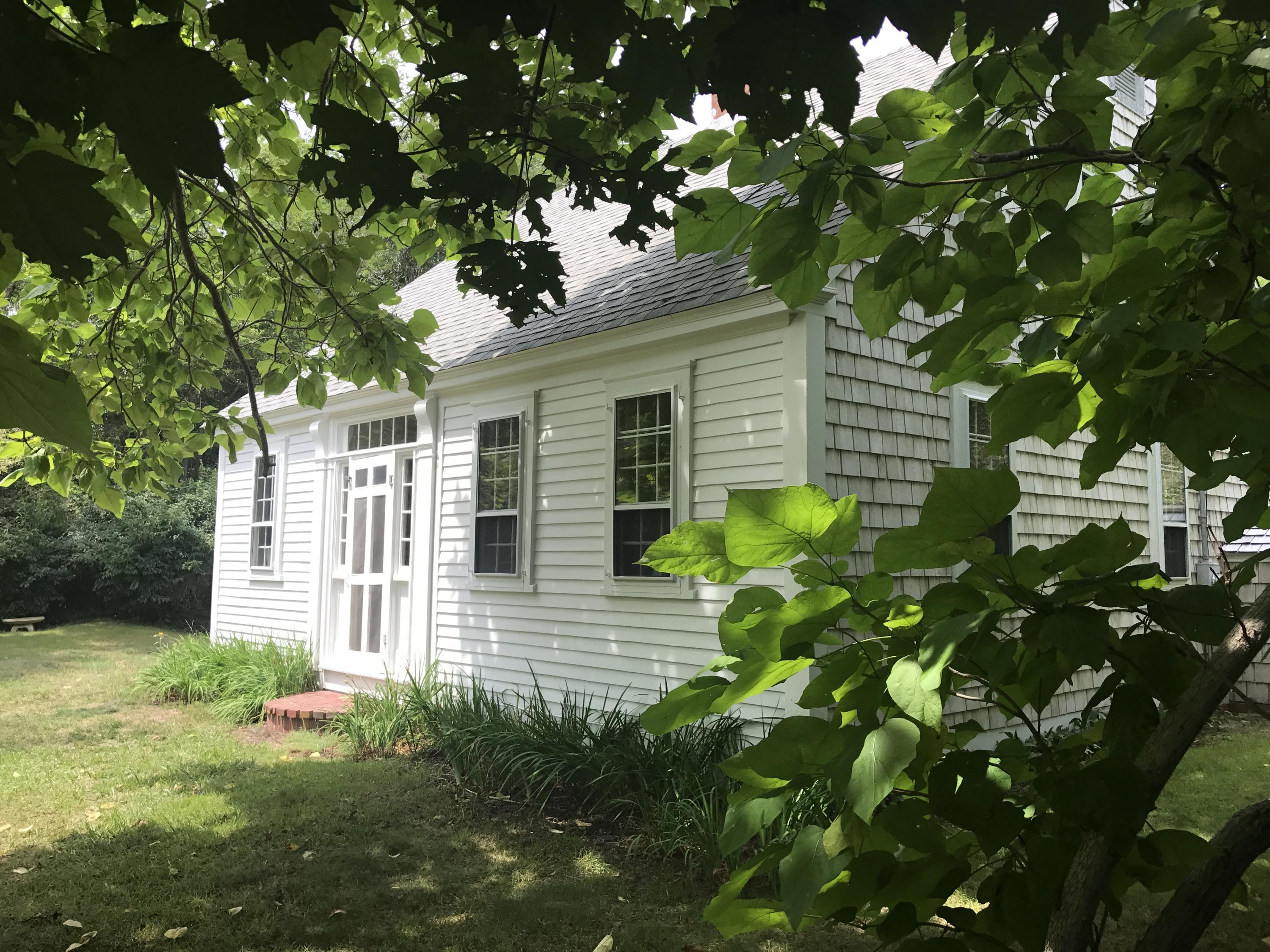 35 Mill Hill Road Wellfleet, MA 02667 - Photo 1 of 25 a yellow house with a yard