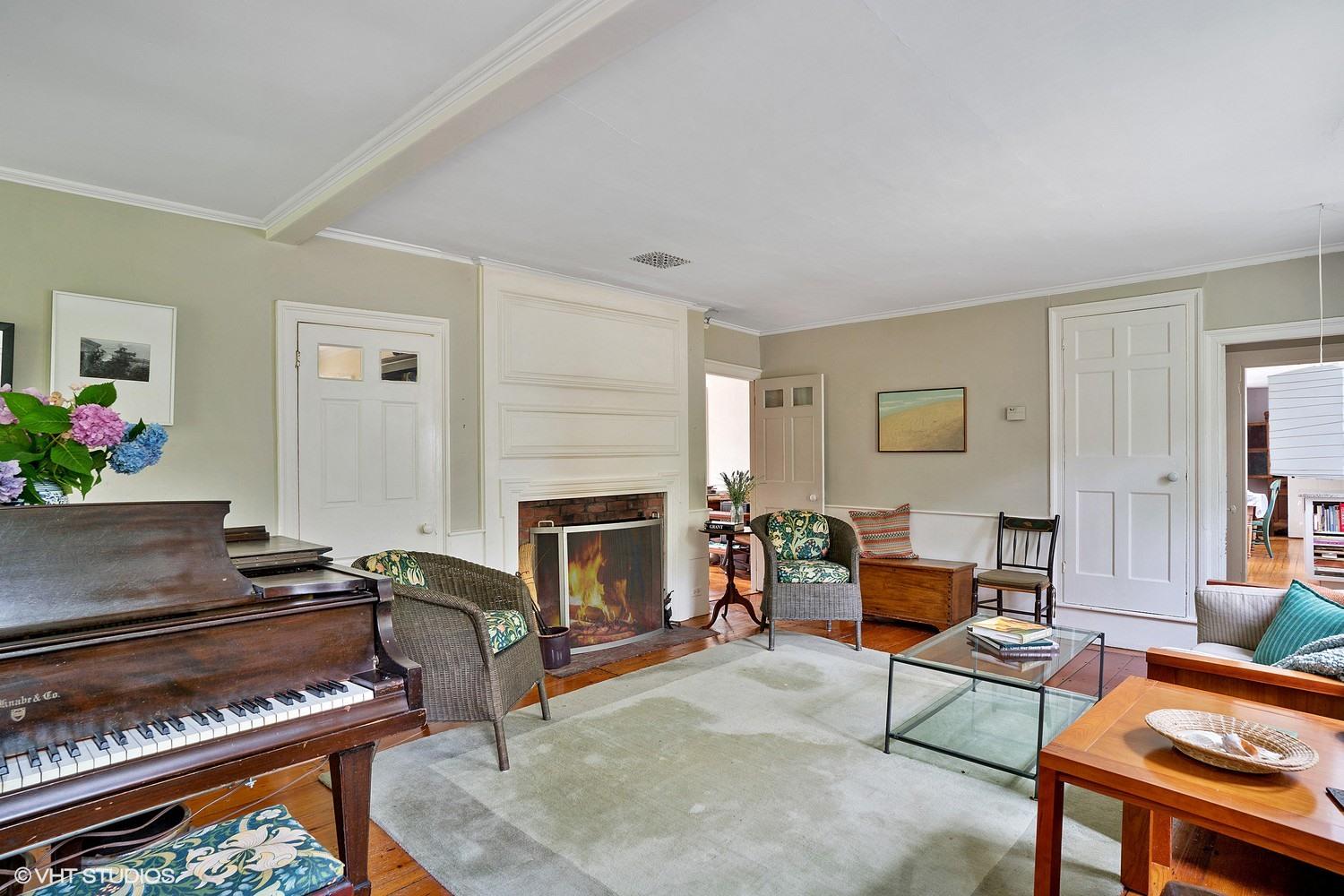 35 Mill Hill Road Wellfleet, MA 02667 - Photo 12 of 25 a living room with furniture a fireplace and a piano