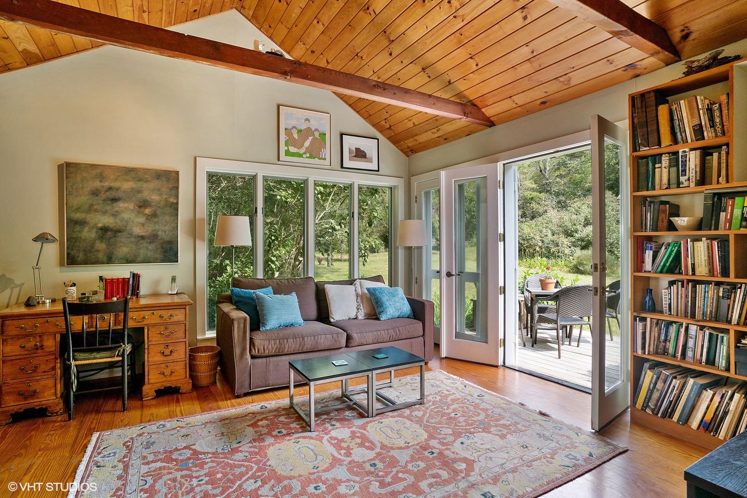 35 Mill Hill Road Wellfleet, MA 02667 - Photo 13 of 25 a living room with large furniture and a book shelf