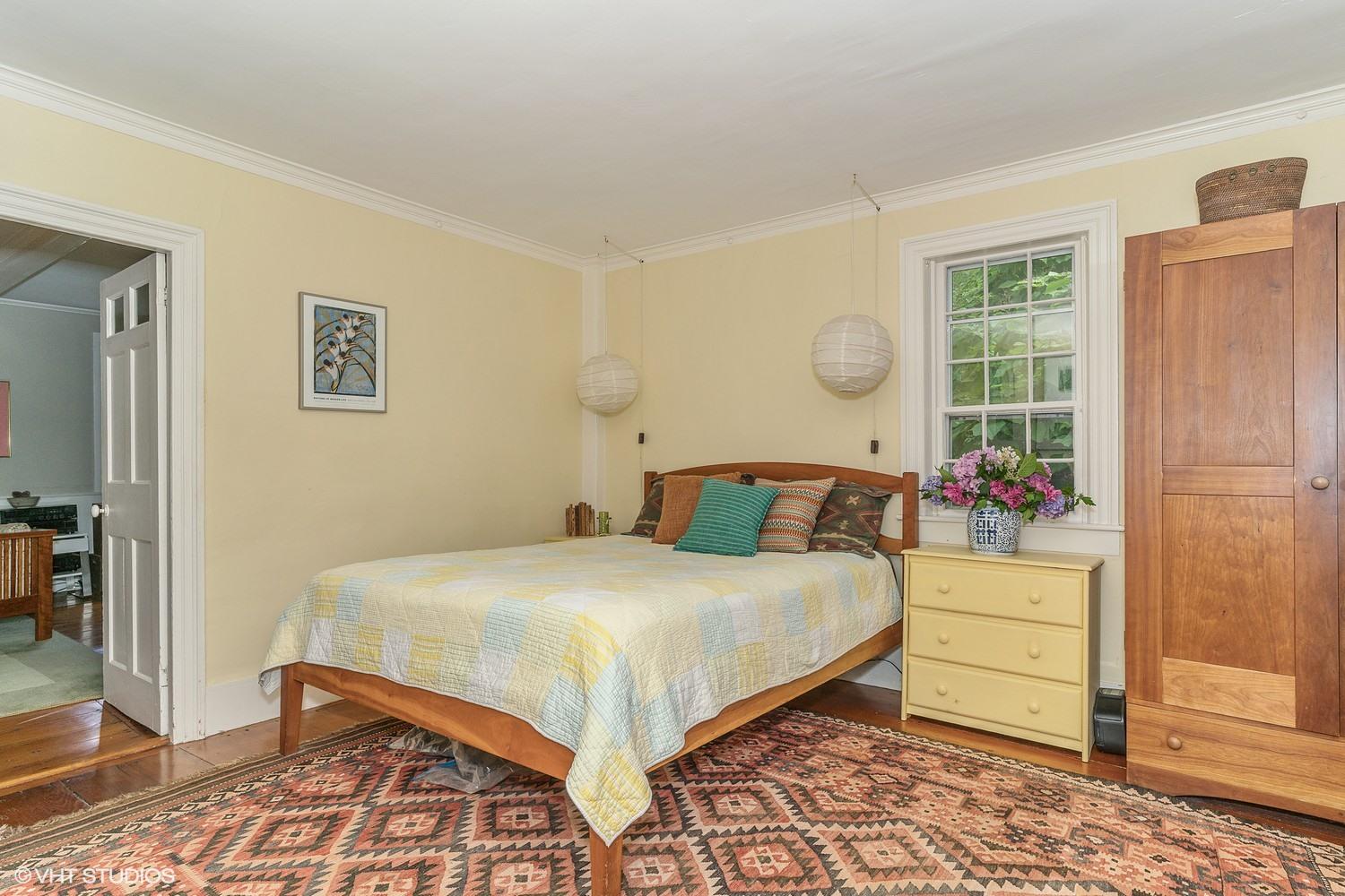 35 Mill Hill Road Wellfleet, MA 02667 - Photo 14 of 25 a bedroom with a large bed and a dresser