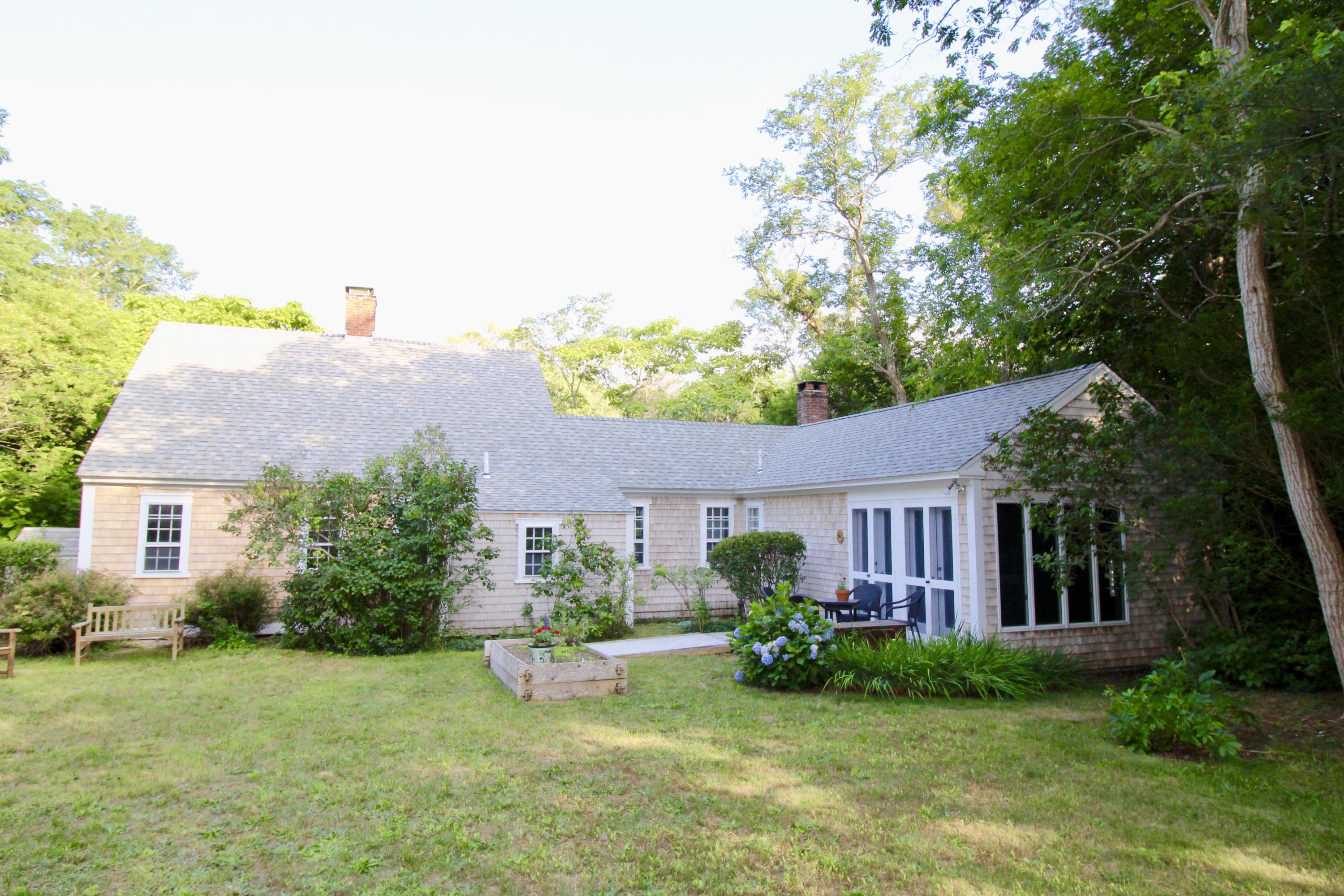 35 Mill Hill Road Wellfleet, MA 02667 - Photo 6 of 25 a front view of a house with garden