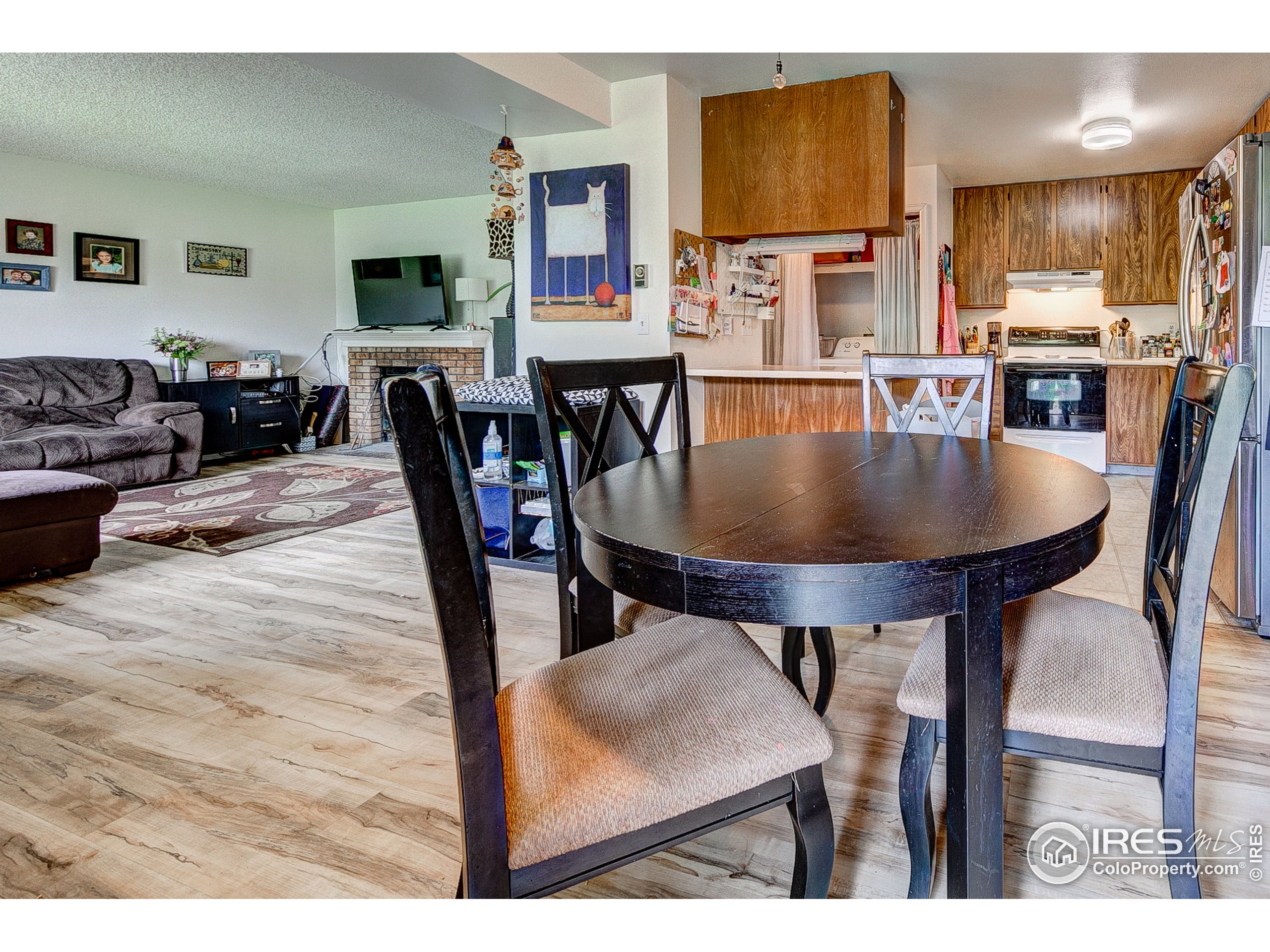 1640 Kirkwood Drive, Unit 2022 Fort Collins, CO 80525 - Photo 11 of 20 a living room with furniture a flat screen tv and kitchen view