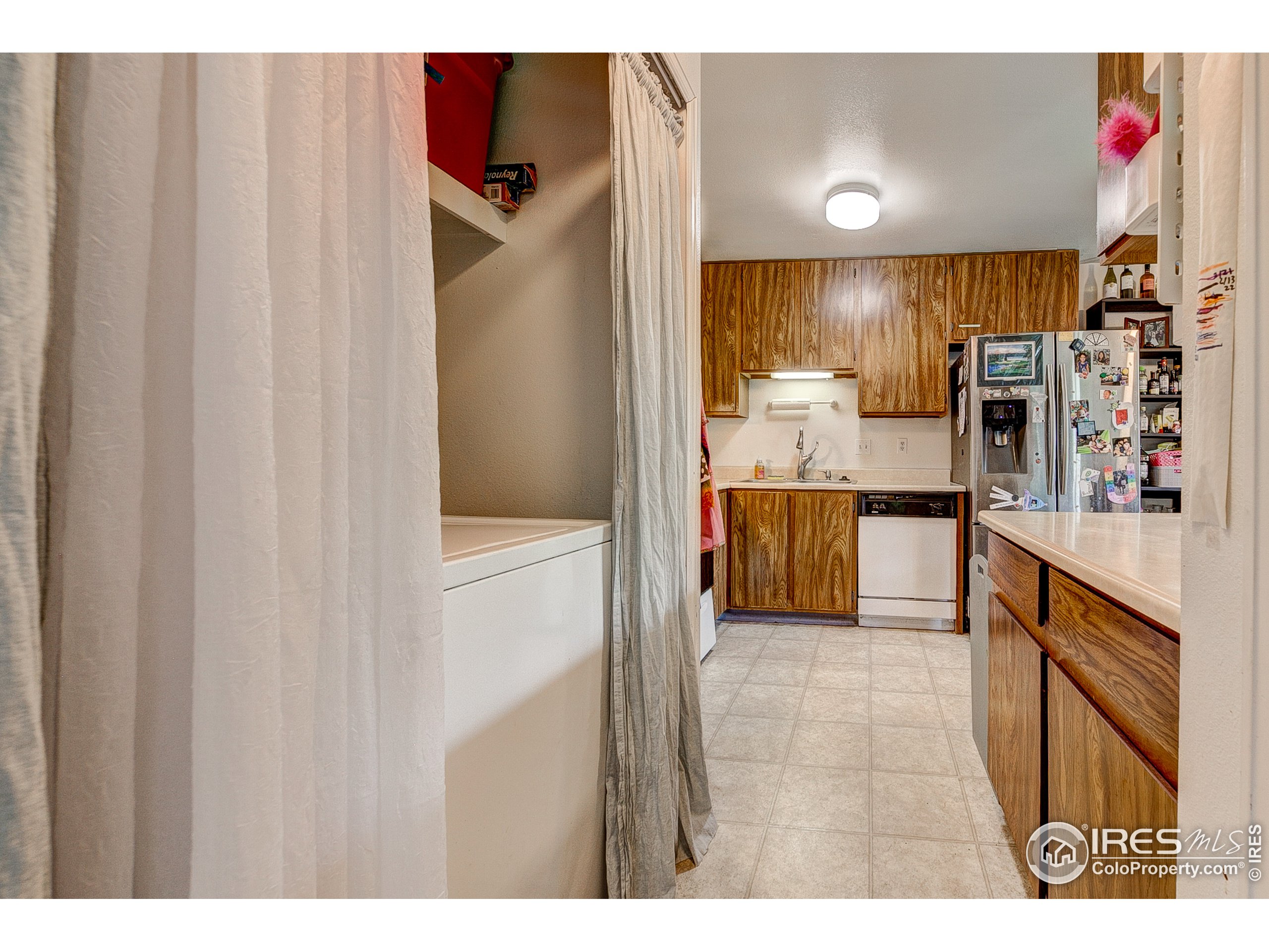 1640 Kirkwood Drive, Unit 2022 Fort Collins, CO 80525 - Photo 13 of 20 a open kitchen with granite countertop a refrigerator and a sink