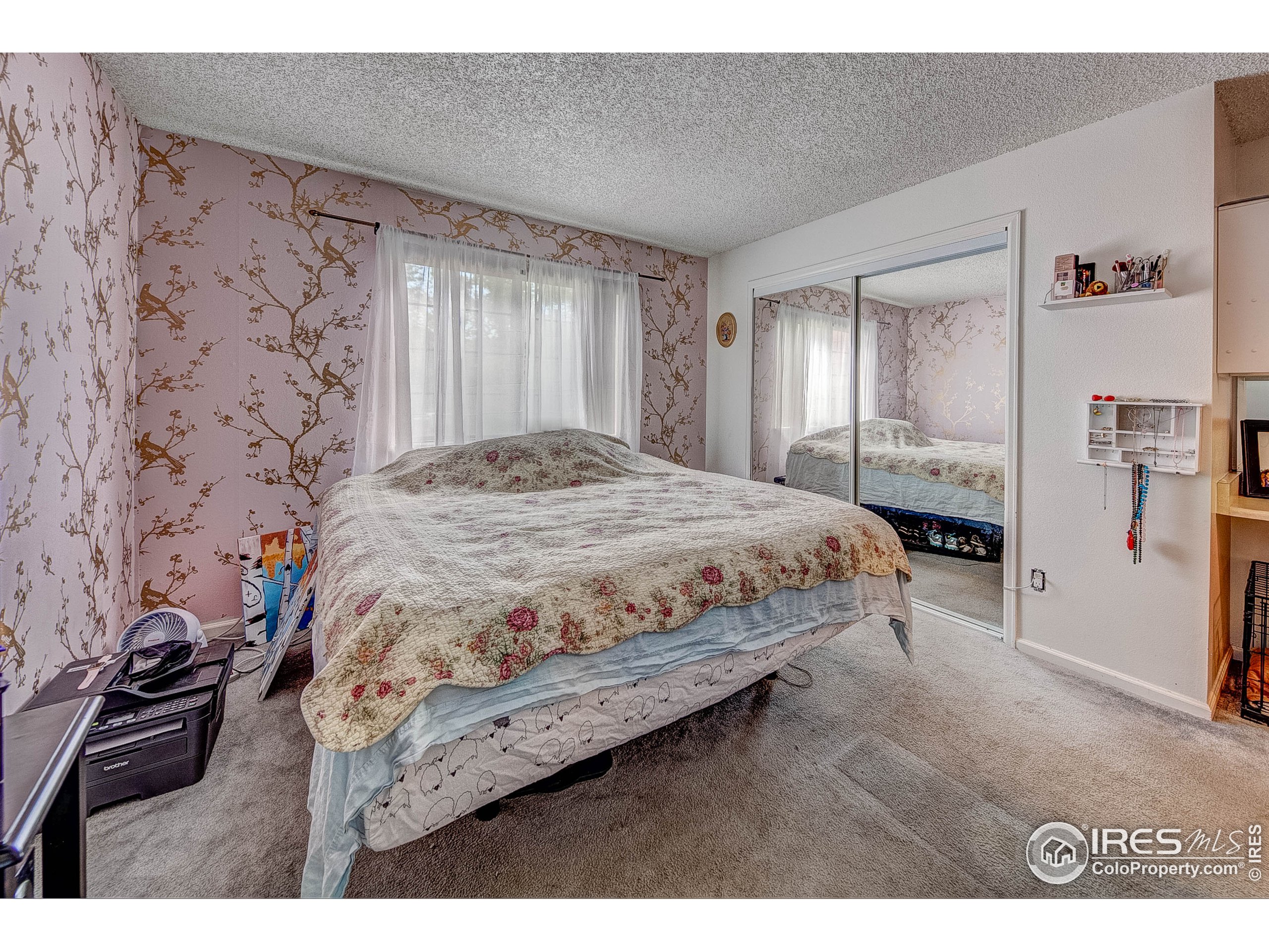 1640 Kirkwood Drive, Unit 2022 Fort Collins, CO 80525 - Photo 15 of 20 a bedroom with a bed next to a window