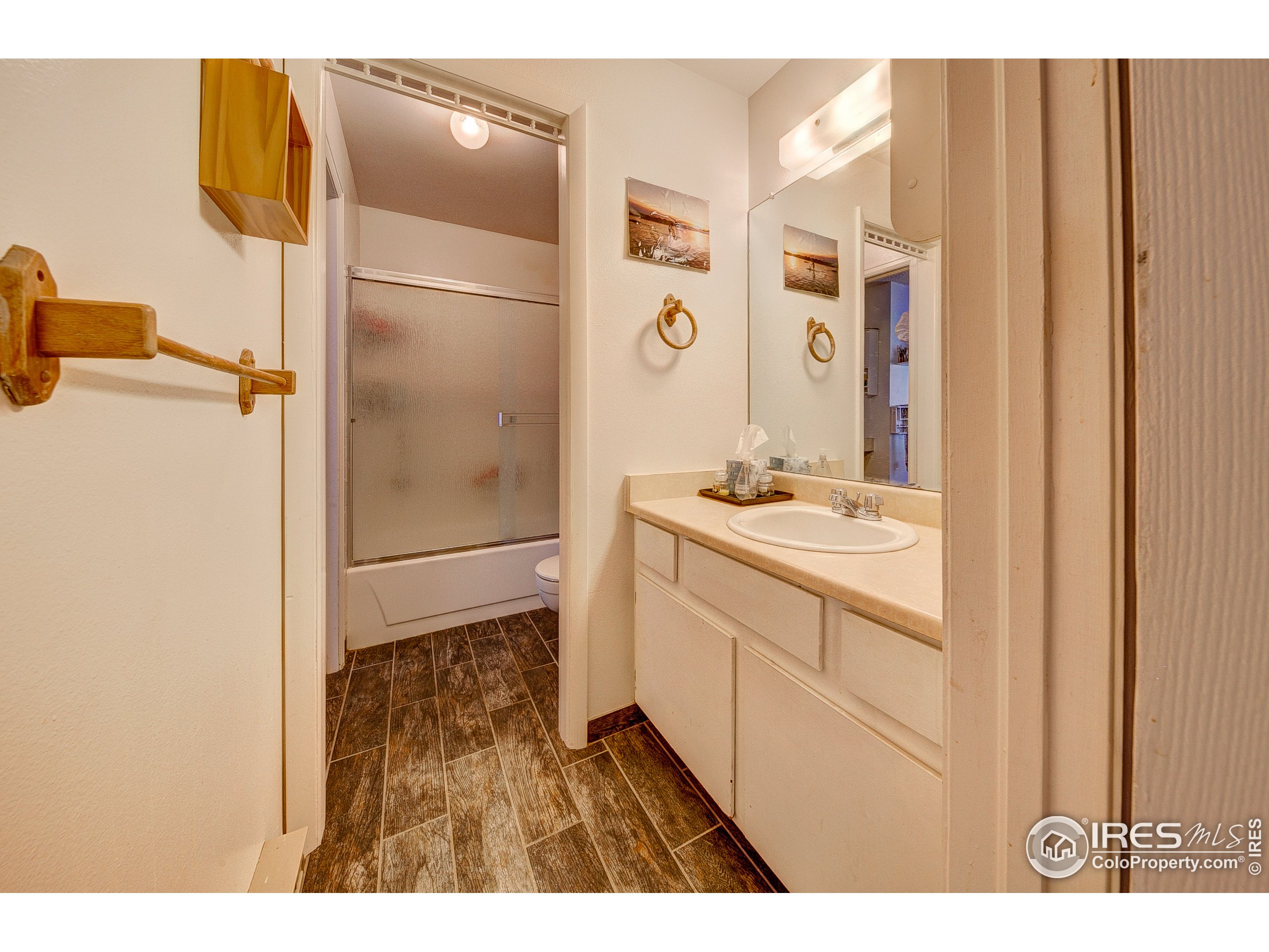 1640 Kirkwood Drive, Unit 2022 Fort Collins, CO 80525 - Photo 17 of 20 a bathroom with a sink and a mirror