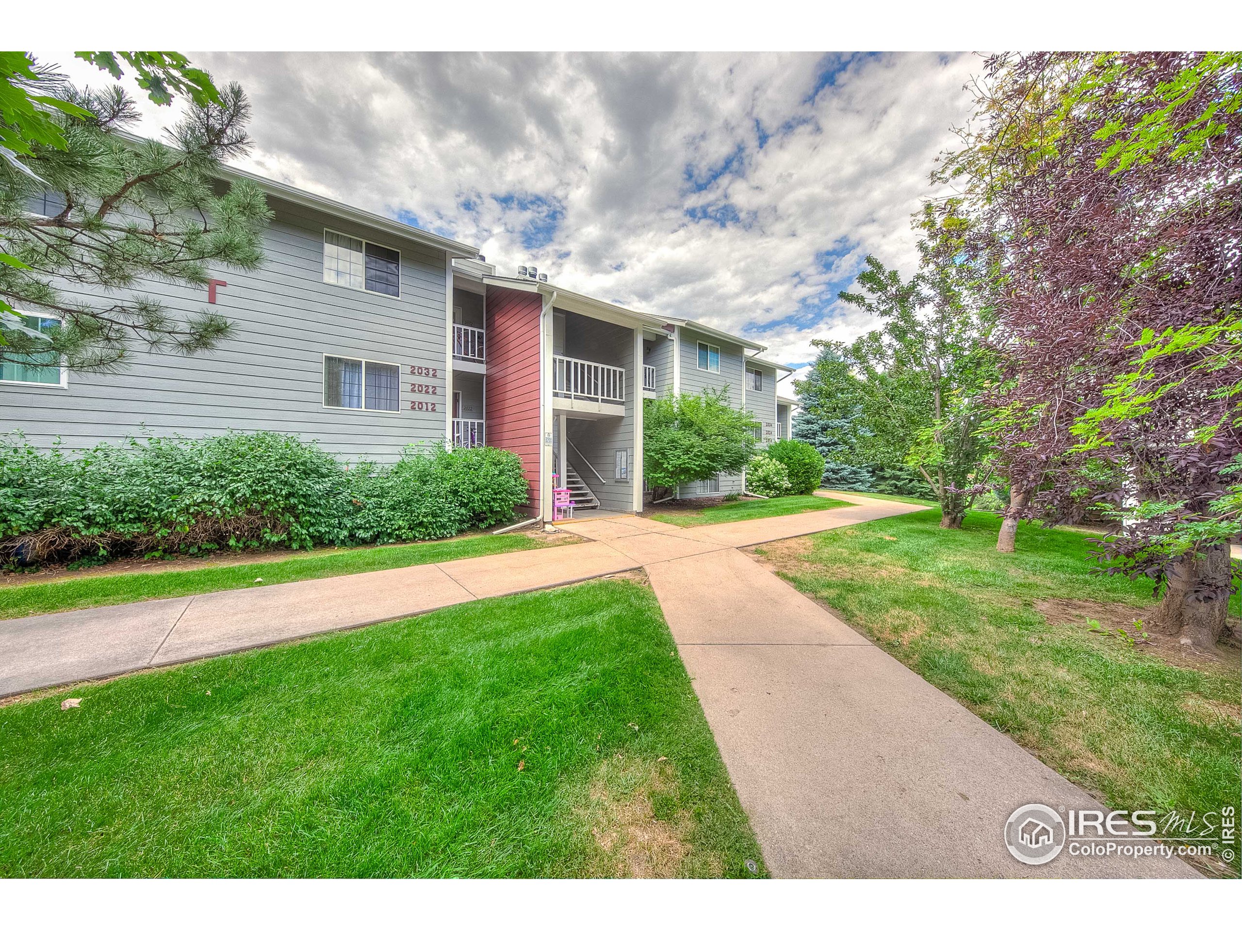1640 Kirkwood Drive, Unit 2022 Fort Collins, CO 80525 - Photo 3 of 20 a view of a house with a yard