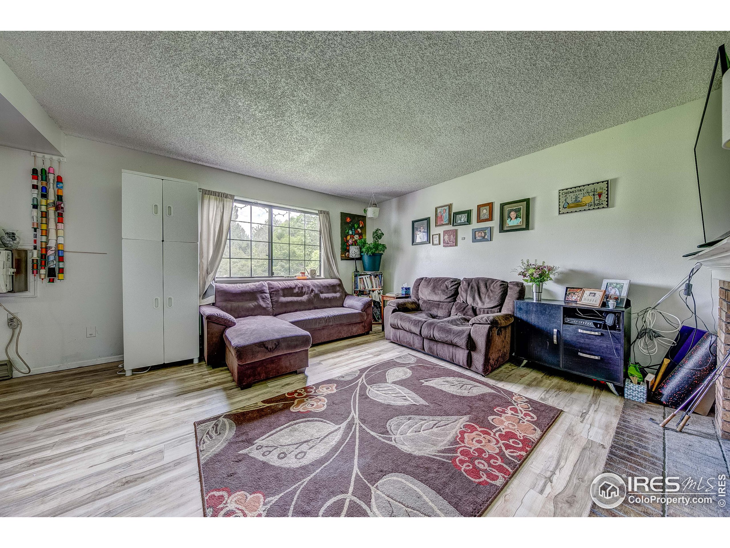 1640 Kirkwood Drive, Unit 2022 Fort Collins, CO 80525 - Photo 7 of 20 a living room with furniture and a wooden floor