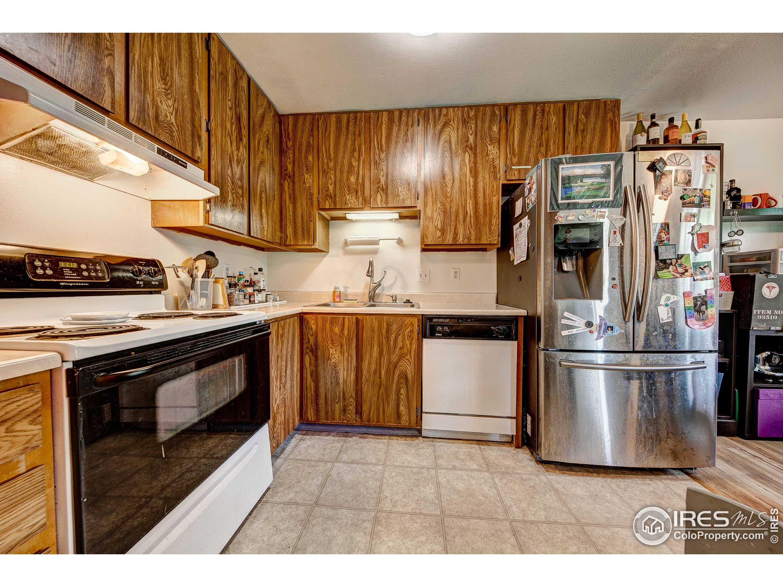 1640 Kirkwood Drive, Unit 2022 Fort Collins, CO 80525 - Photo 9 of 20 a kitchen with stainless steel appliances granite countertop a stove a refrigerator and a microwave